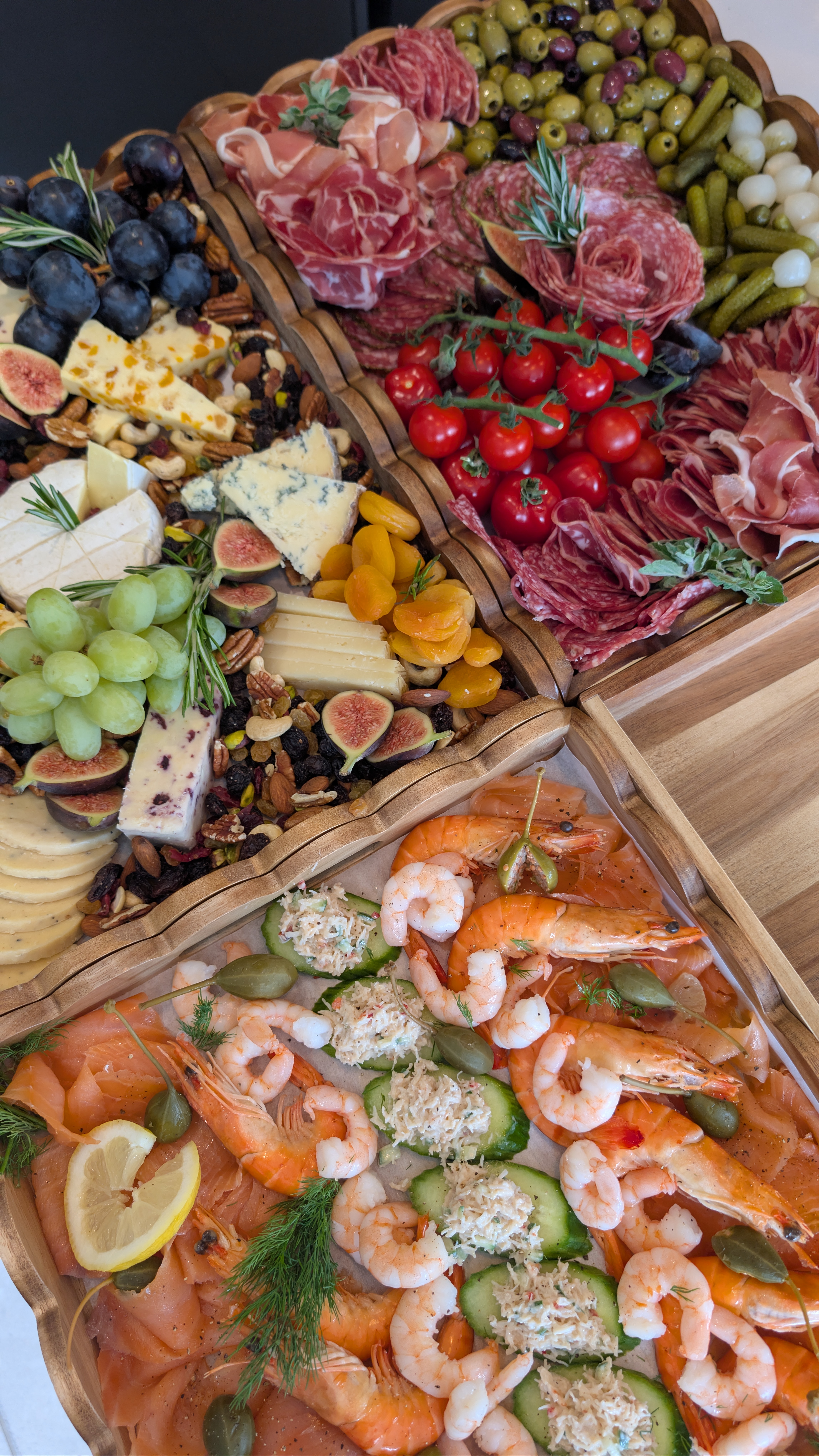 A full grazing spread with cheese, fruit, charcuterie and seafood